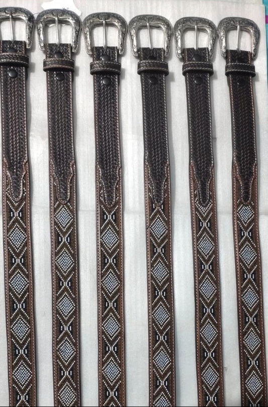 Set of black leather belts with silver buckles on a white background